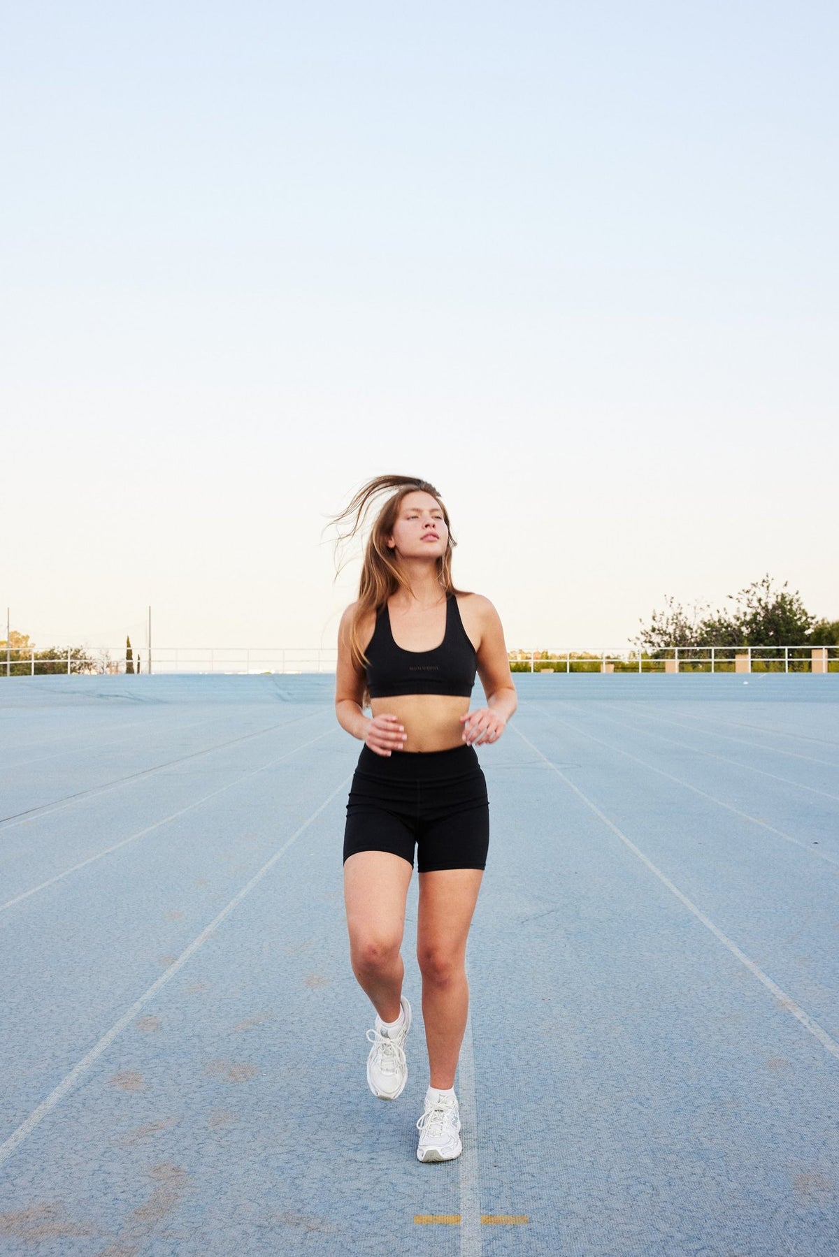Flo organic cotton bike shorts in black, running on a track